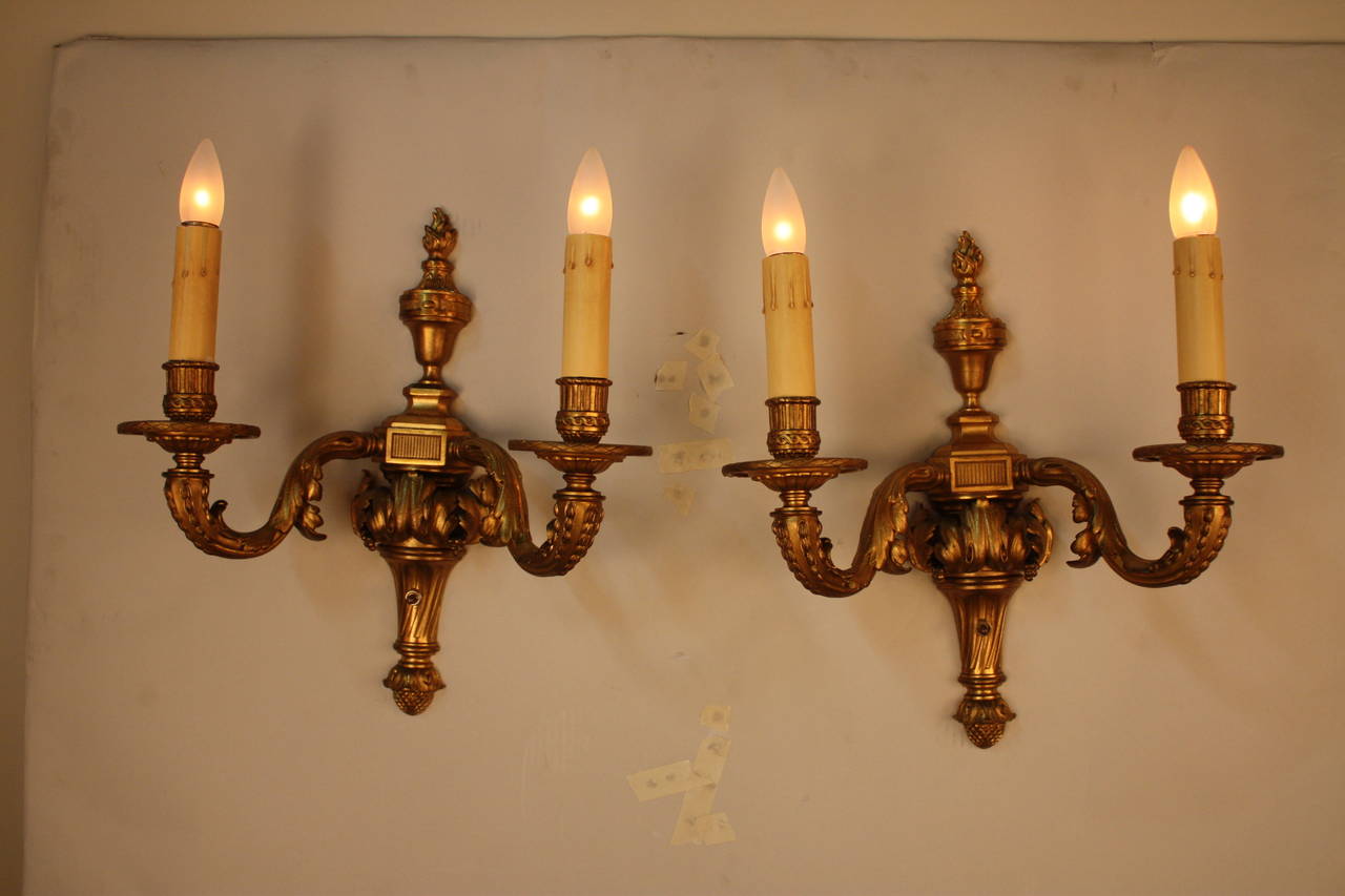Fantastic pair of double-arm gilt bronze French wall sconces.