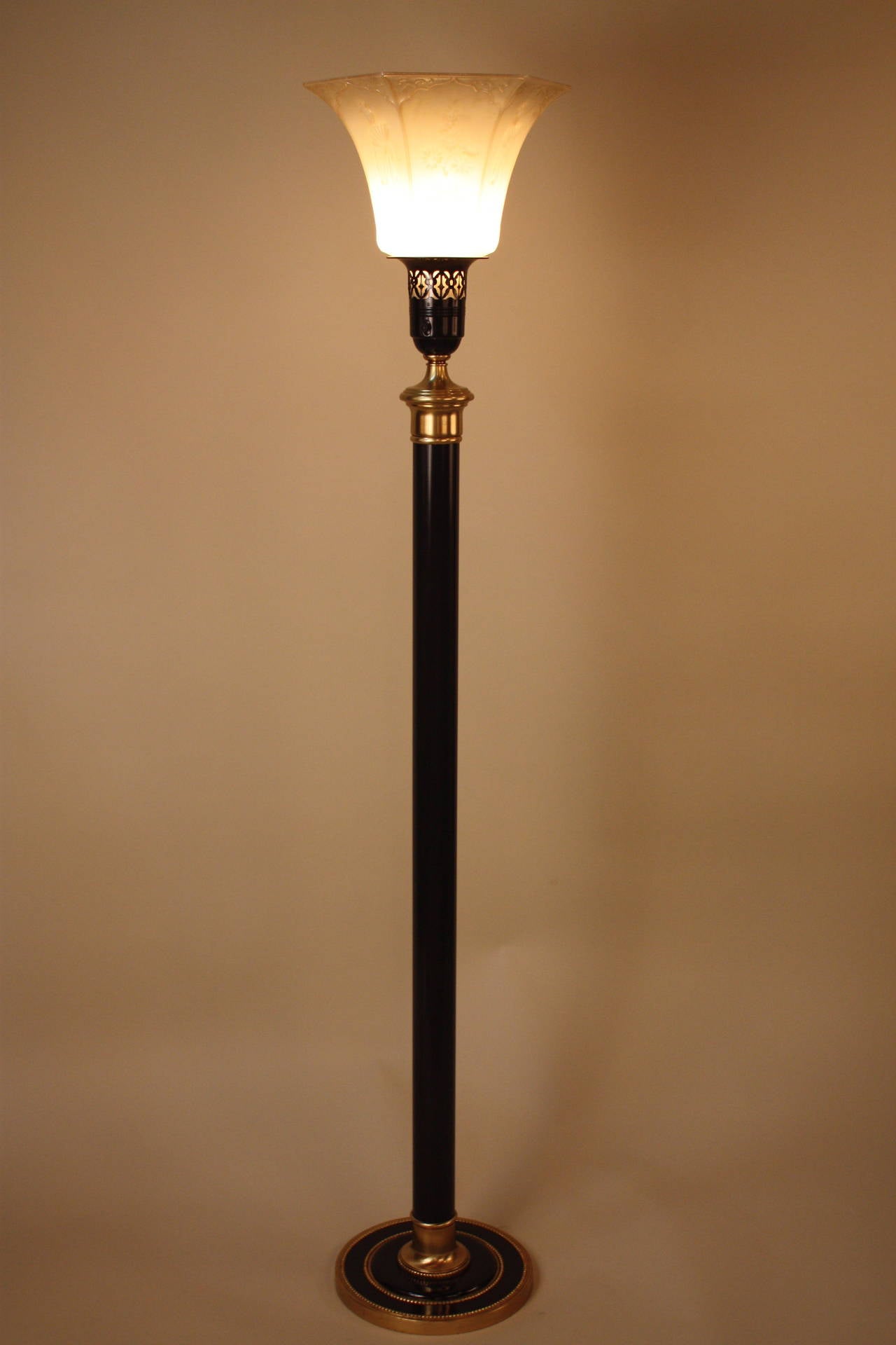 Elegant American 1950s torchieres in black lacquer brass with influence of orientalism on glass shade.