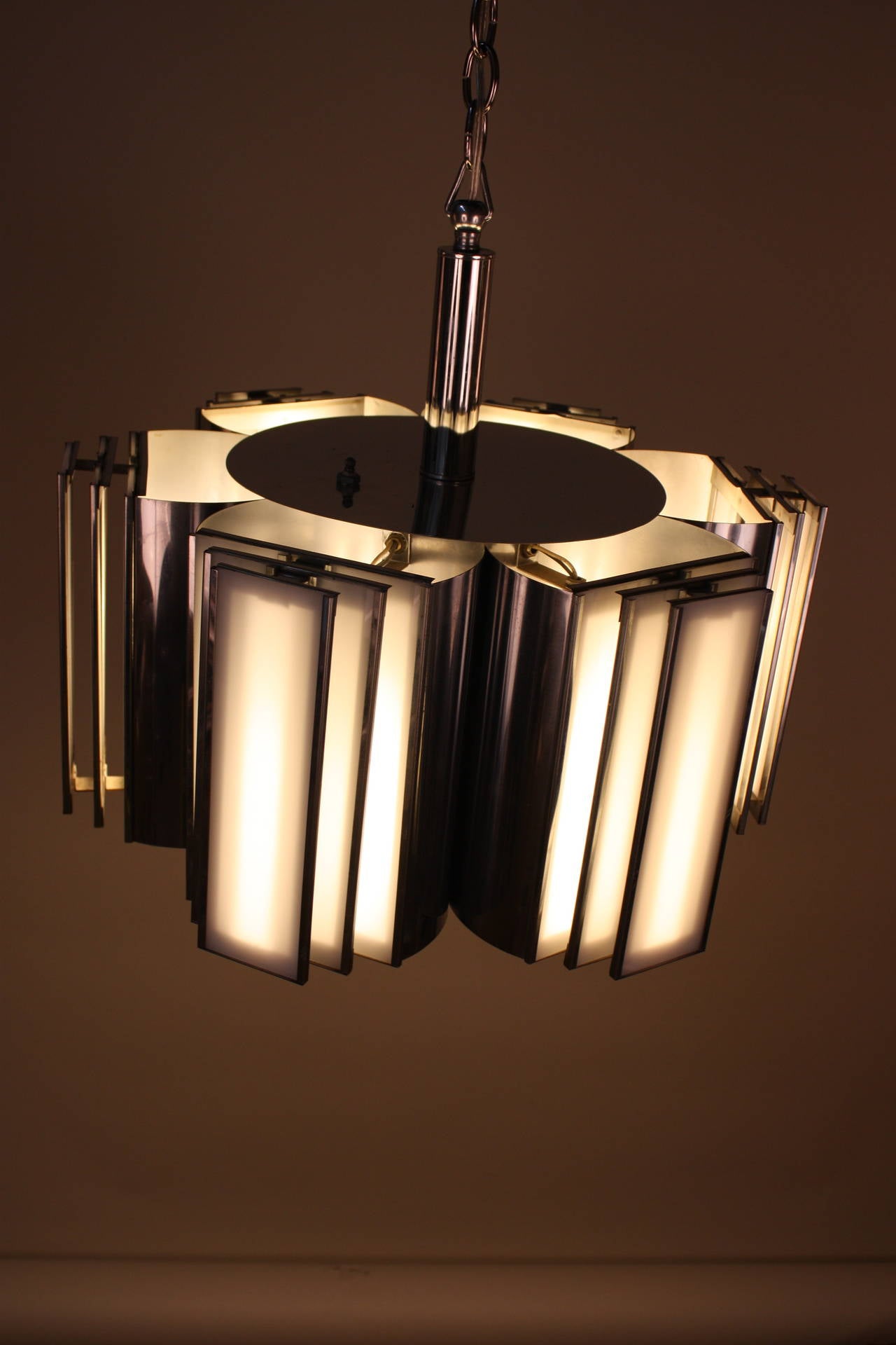 Very elegant and unusual modern six-light chrome chandelier with fiberglass lenses.