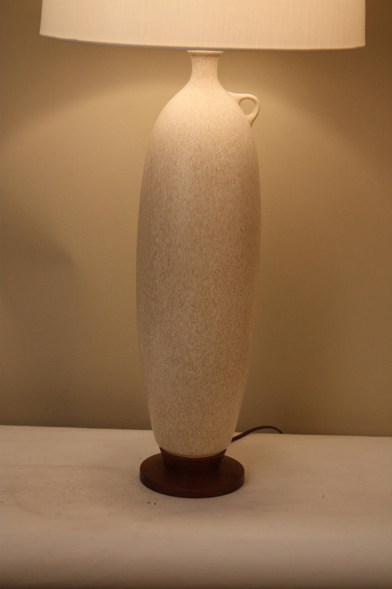 Simple but elegant Beige porcelain lamp with beautiful texture and teakwood base.