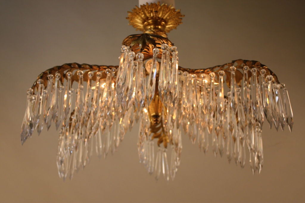 THIS BEAUTIFUL PALM TREE LIKE FIXTURE IS BRONZE AND HAS SIX LIGHTS THAT IS SURROUNDED BY CRYSTALS