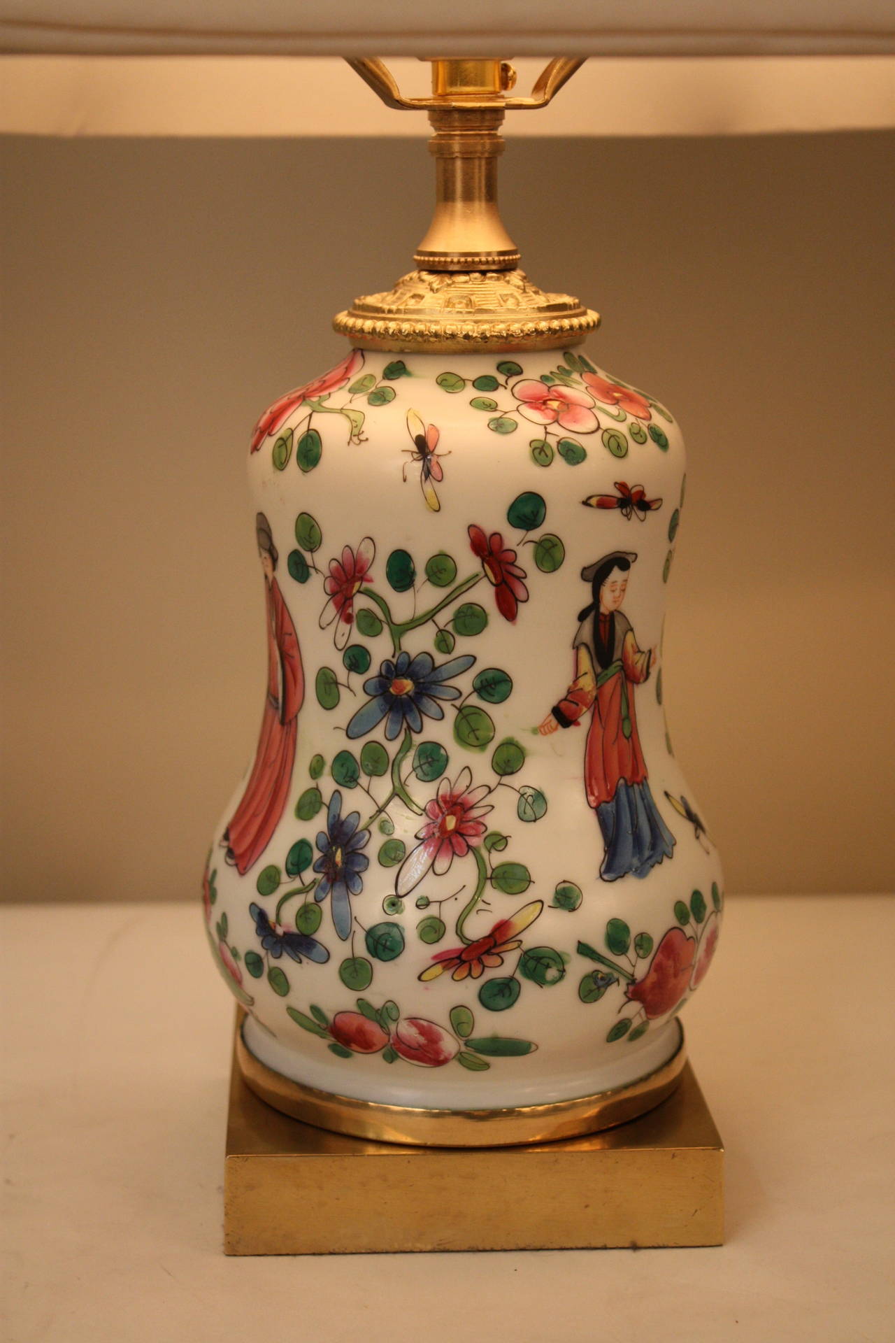 A beautiful hand-painted porcelain modified and electrified oil lamp influenced by oriental art with Classic bronze mounting makes this piece absolutely stunning.