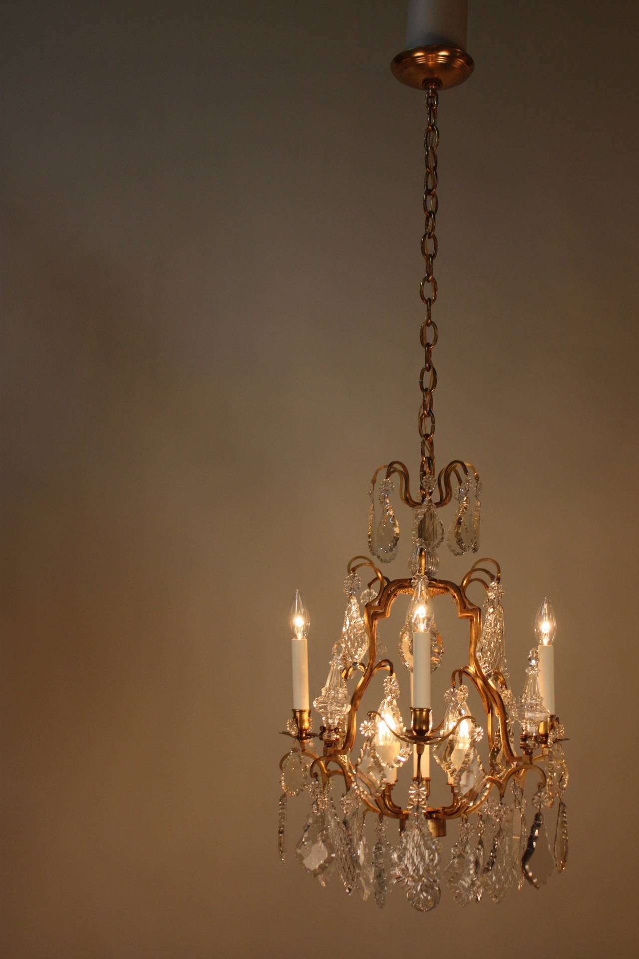 Impressive early 1930s nine-light crystal and bronze chandelier.