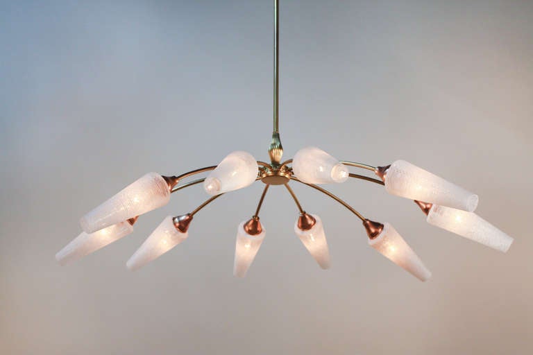 A fantastic 10 light chandelier. Crafted in Italy during the 1950's, this gorgeous chandelier features a two tone design made of oxidized and gold leaf bronze. Copper on bronze canopy and cups provide a subtly beautiful contrast to the oxidized and