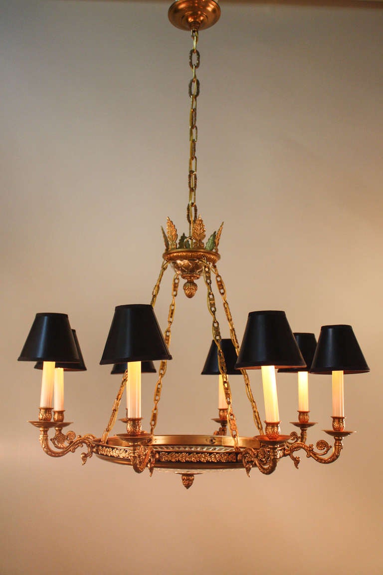 An elegant mid-century chandelier made in the empire style, this chandelier is truly beautiful. The magnificent detail work throughout the piece is exemplary of this chandelier's superb artistry and craftsmanship. In a unique touch, this eight light