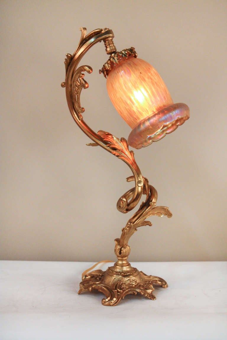 Masterfully crafted in France during the 1930's, this beautiful bronze table lamp features an classic, organically-inspired, Art Nouveau design. 

A brilliant art glass tops off this fabulous table lamp (see image 3 for greater detail), making for