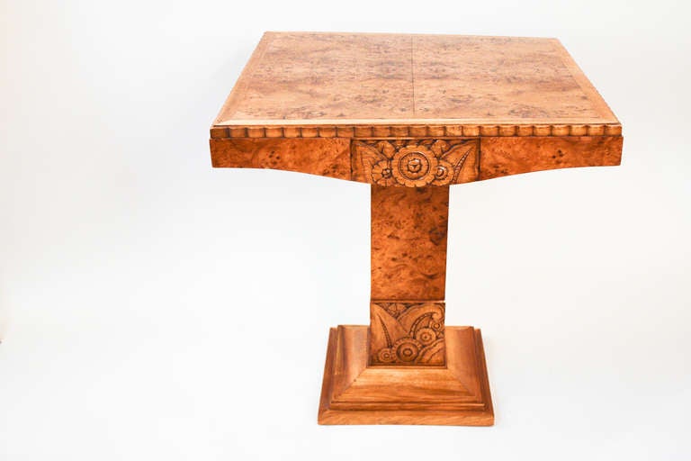 Revel in the artistry and classic craftsmanship of this beautiful wooden table. A handcarved piece, this table features elegant detail work and exquisite natural wood grain.
