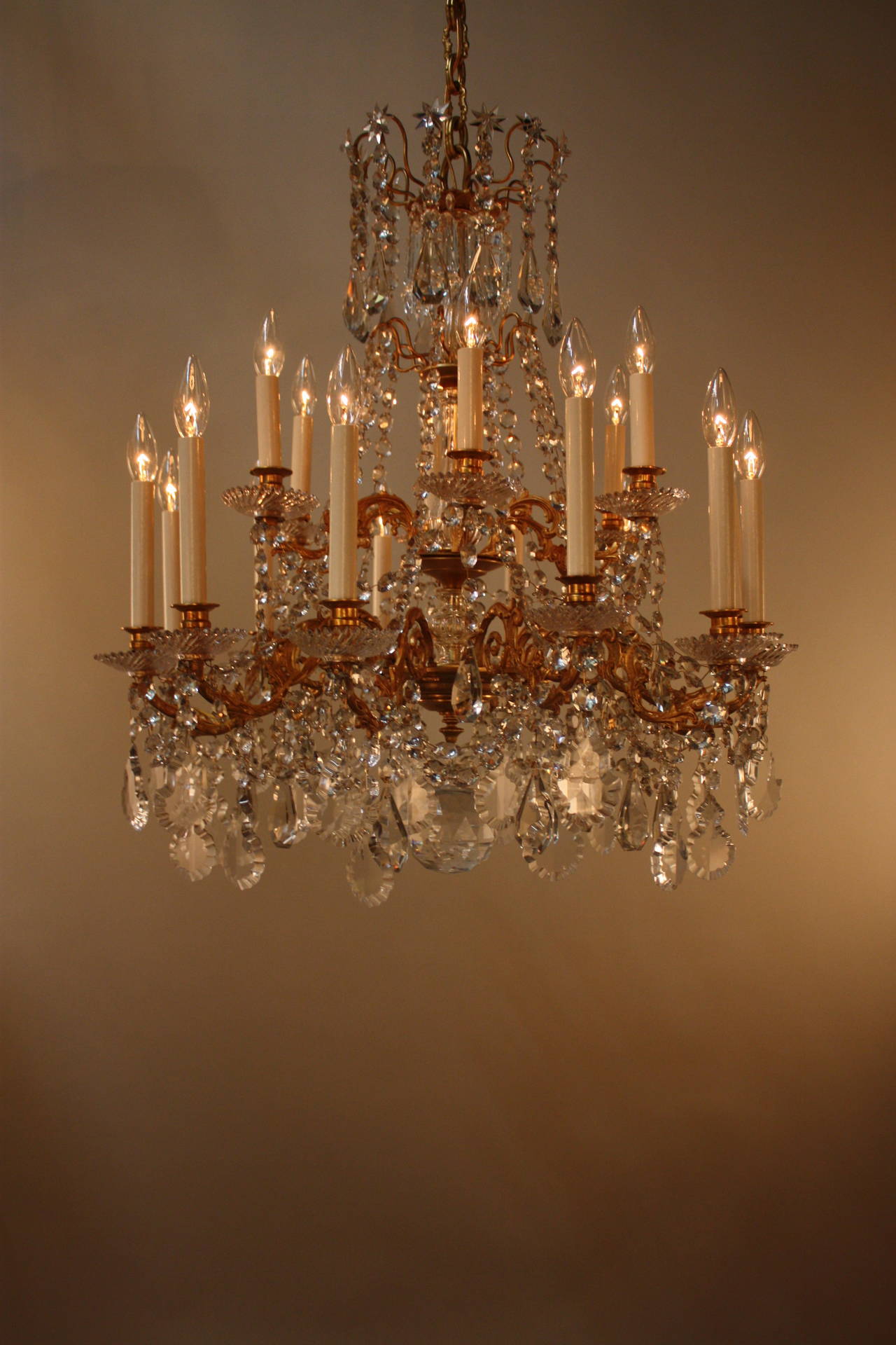 This stunning 19th century chandelier from France is made of beautiful bronze and crystal. With eighteen lights, this fixture is the definition of elegance.