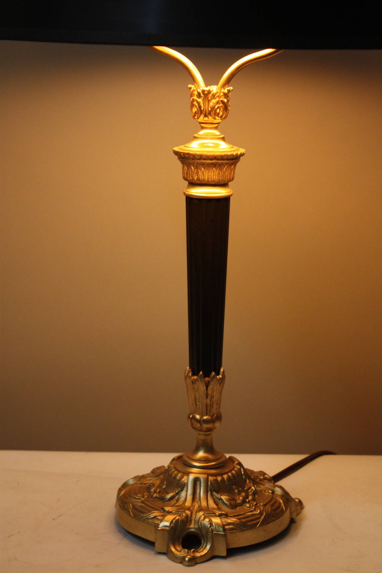 This fantastic French table lamp from 20th century. Made of classic black lacquer and bronze with ornate details.