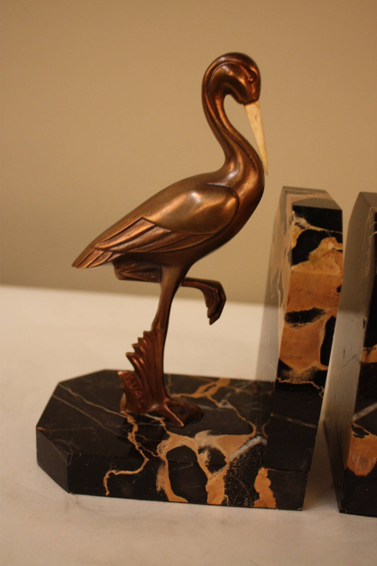 A beautiful pair birds made from bronze with bone peaks.