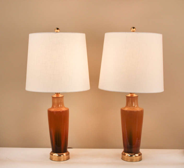 Elegant, yet simple, this pair of table lamps is truly stunning. Made in France during the 1930's, these pieces feature a gorgeous transitional color design.  The beautiful bronze bases and tops adds a timeless touch to these great pieces.