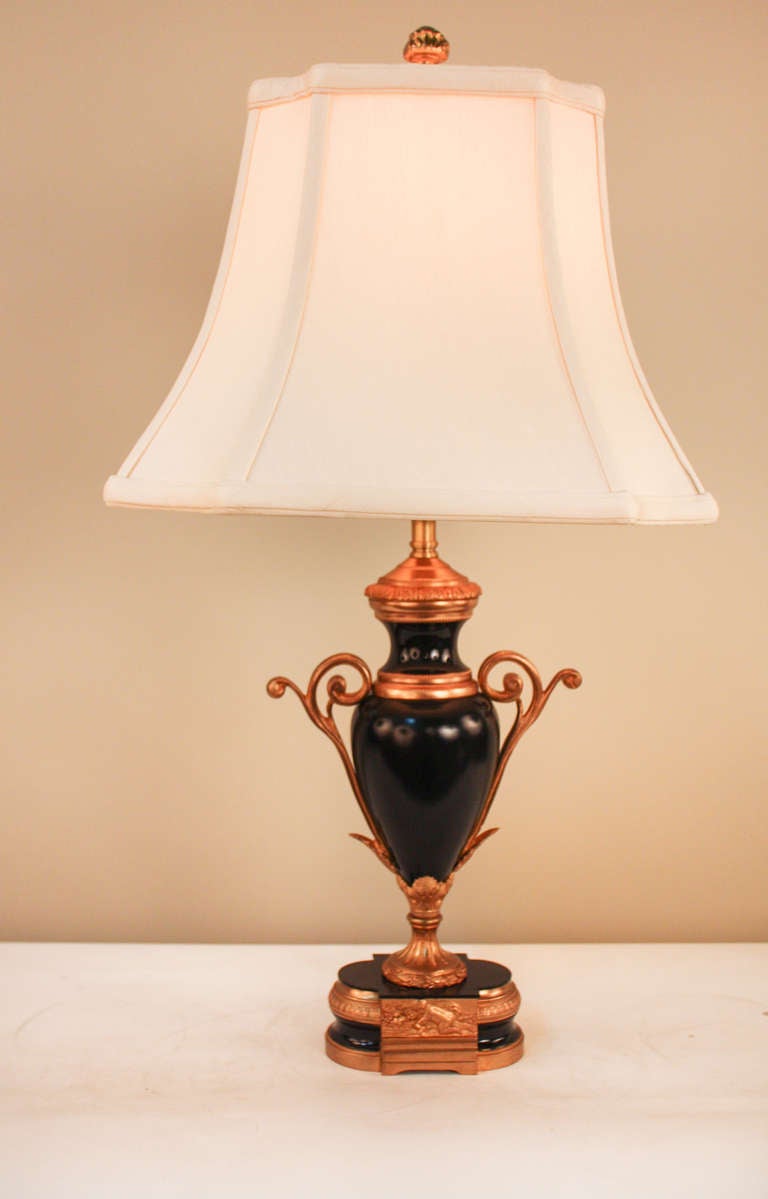 Crafted in France during the early 20th century, this gorgeous table lamp features a classic bronze and black lacquer design. Beautiful detail work, characteristic of the Art Nouveau style, makes this elegant table lamp truly special.