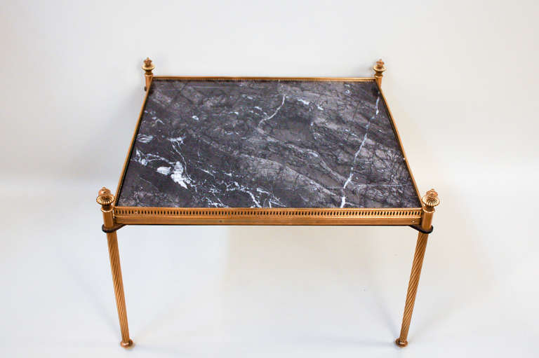 A gorgeous low coffee/side table. Made in France during the 1950's, this elegant table features beautiful bronze work and a fantastic black marble top.