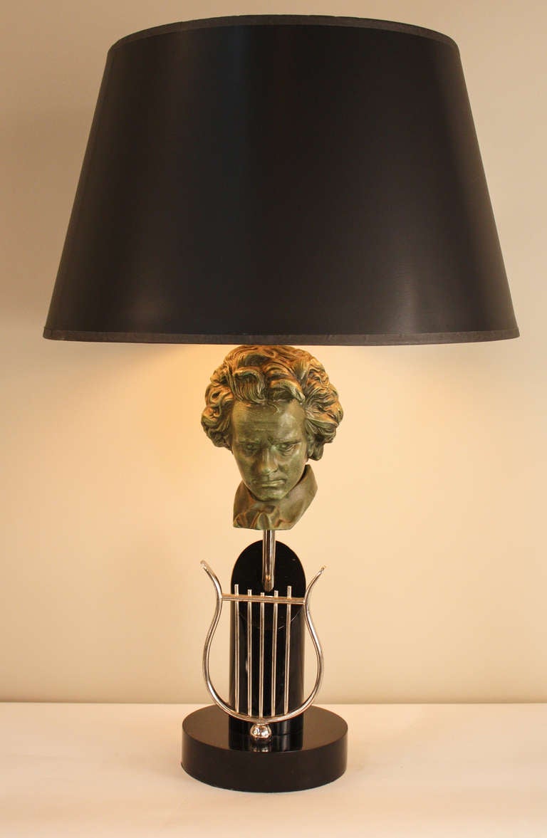 This elegant 1950's table lamp features a wonderfully sculpted Beethoven bust centerpiece. A double light table lamp, this piece is made of beautiful black lacquer over metal, and silver over metal, and is topped off with a great black shade with