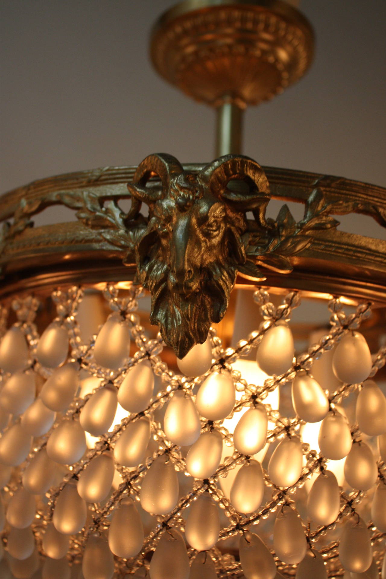 A beautiful three light flush mount basket chandelier. Crafted in France during the 1930s, this elegant chandelier features hundreds of frosted and clear crystals and an ornately detailed bronze rim.