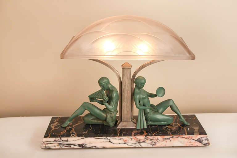 A very rare Art Deco lamp showing a semi-nude sculpture of man and woman in sitting position playing music. This fantastic lamp has been designed by famous sculptor Jacques Limousin, glass by J Robert and the casting by Francaise casting company,