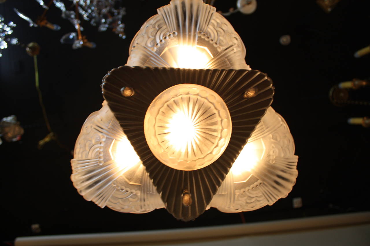 This fantastic Art Deco chandelier has beautifully crafted nickel on bronze metal frame with geometric design glass by Leleu.