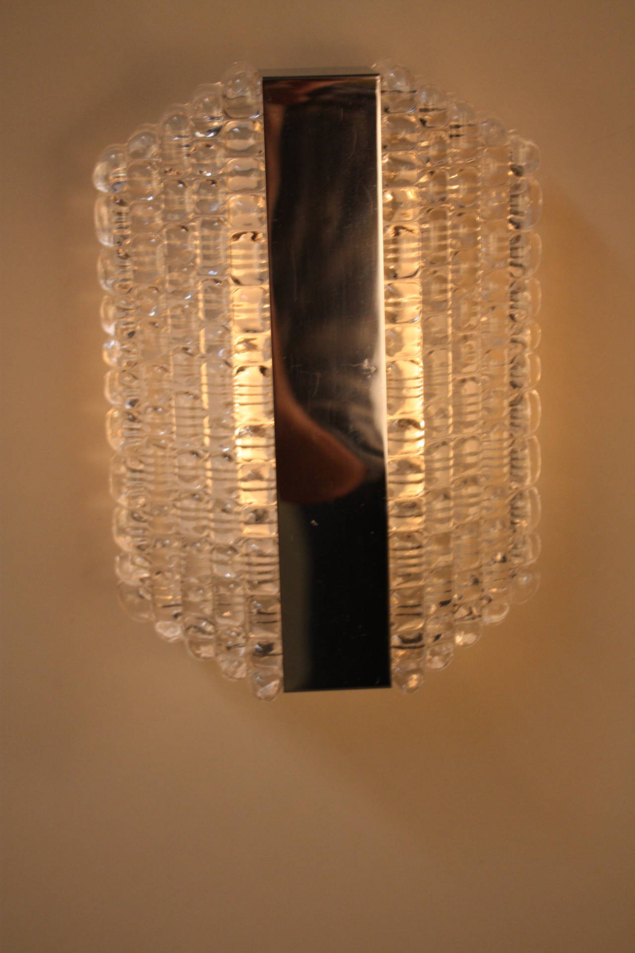 Beautiful pair of texture glass with chrome wall sconces by Kaiser Leuchten which has been modified for USA use.