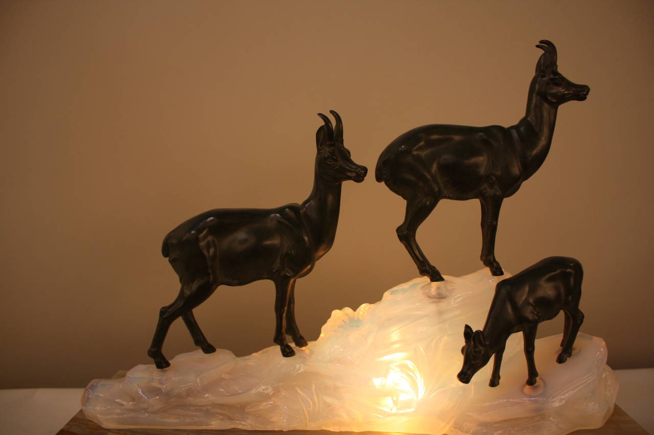A sculpture lamp, goats on the opaline glass in shape of mountain on onyx and black marble base.