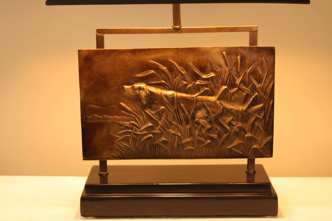 A customized and one of the kind lamp made of bronze plaque and black lacquer wood base.