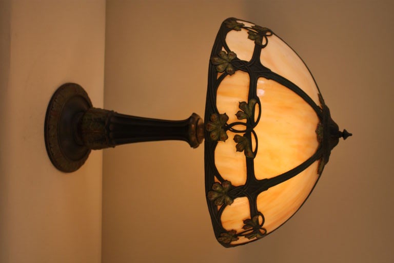 This beautiful American Art Nouveau lamp features a caramel colored glass shade, making for a classic look.