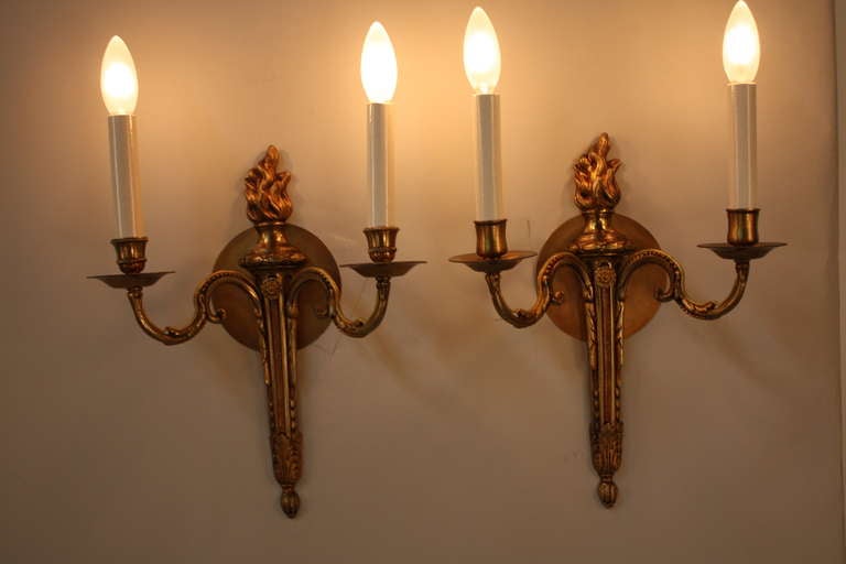 A beautiful pair of double arm wall sconces. Crafted in France, these sconces feature fantastic bronze bodies with great detail work throughout.