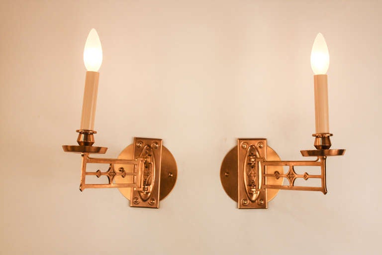 These beautiful Art Nouveau wall sconces are made of classic bronze. The arms are easily adjustable for maximum convenience. <br />
<br />
These sconces have been professionally restored and are designed to be wall mounted. But originally, they held