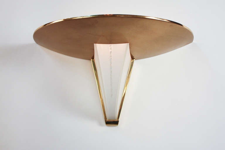This elegant Art Deco wall sconce features an elegant bronze and glass design. Signed by the artist, world renowned lighting designer Jean Perzel; this fixture is truly remarkable.