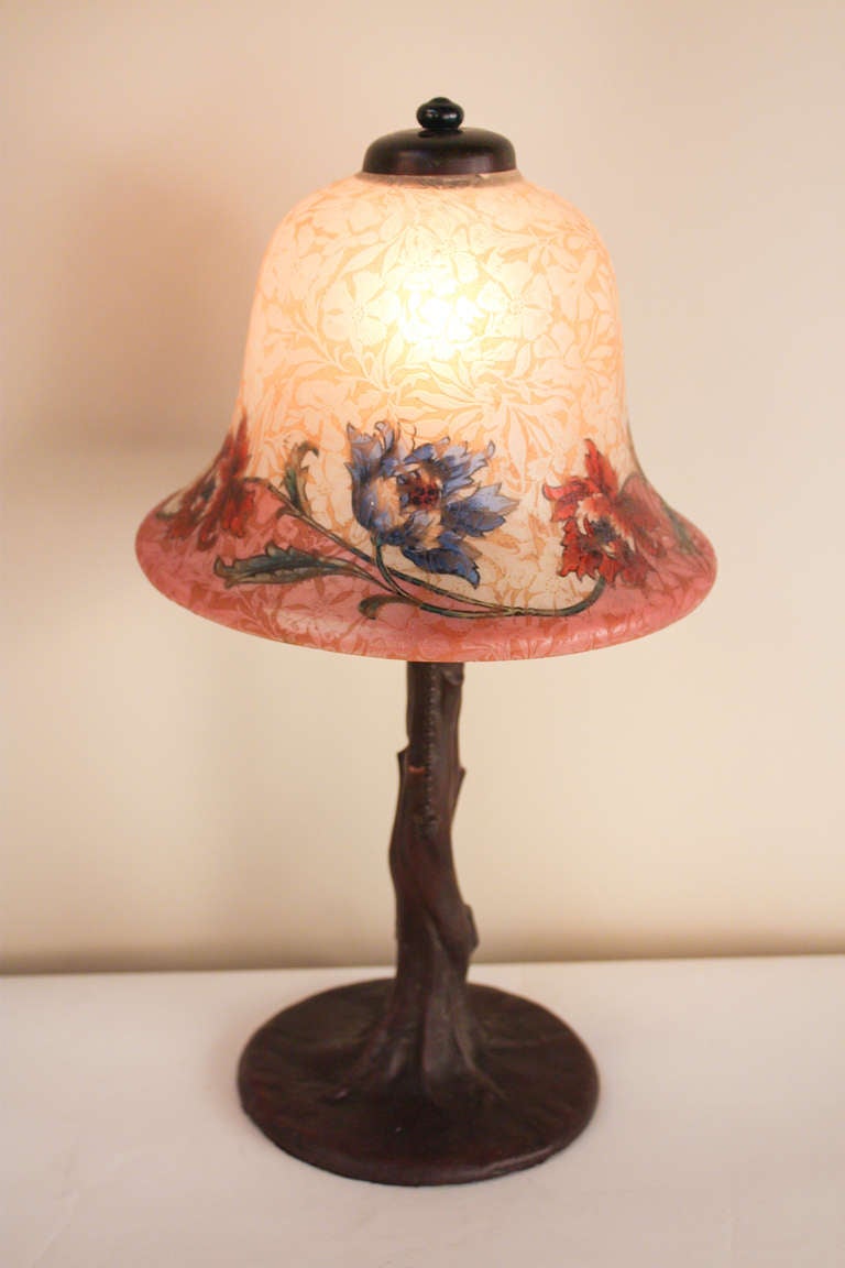 A fantastic table lamp, this piece features a bronze Handel base in the style of a tree trunk, and is topped off with a beautiful painted shade.