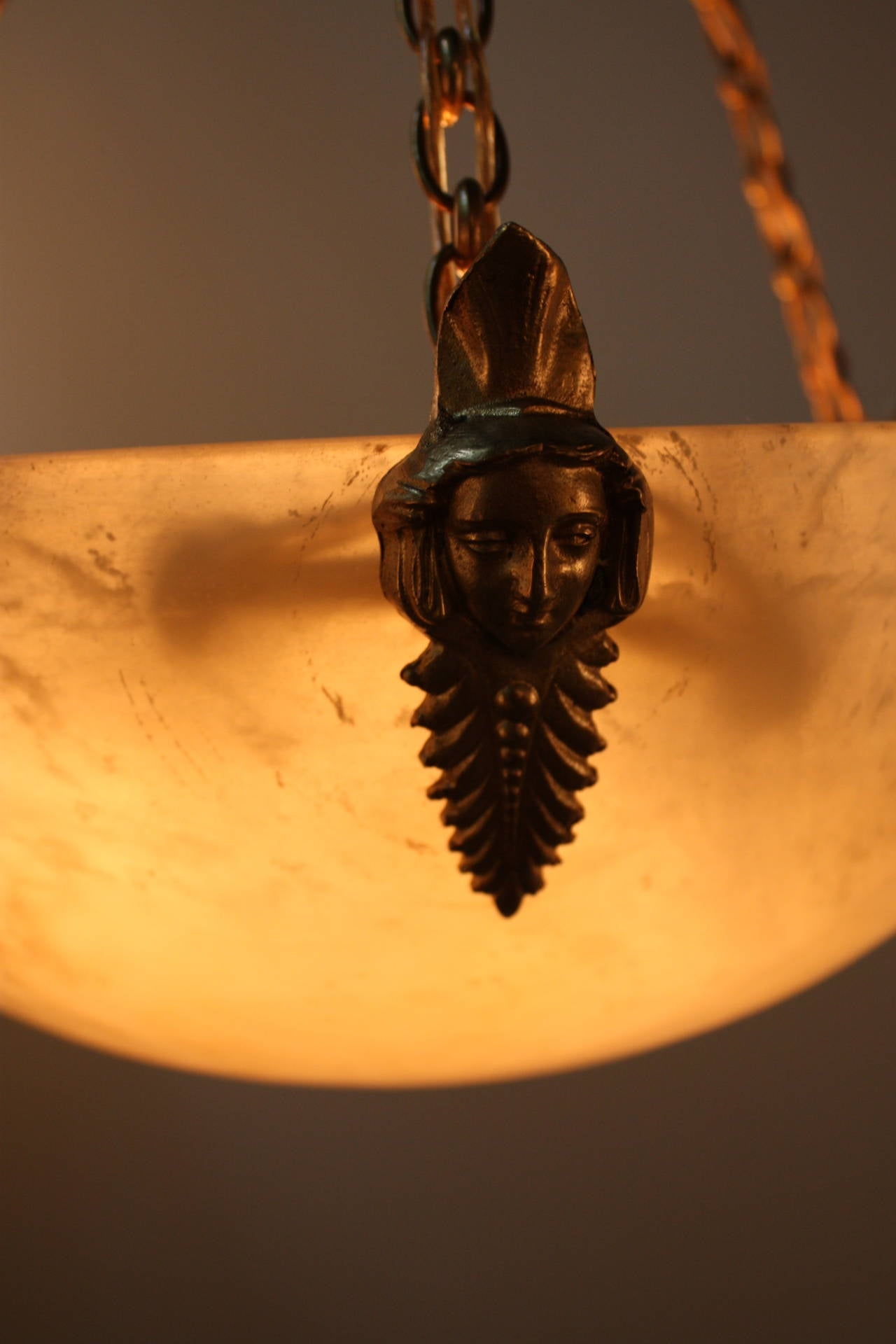 Elegant soft color with some black veins six-light alabaster chandelier with bronze hardware.