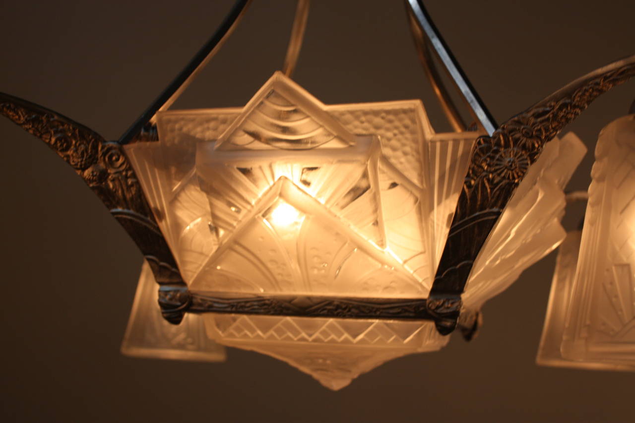 A beautiful French art deco chandelier with elegant geometric glass and nickel on bronze frame.