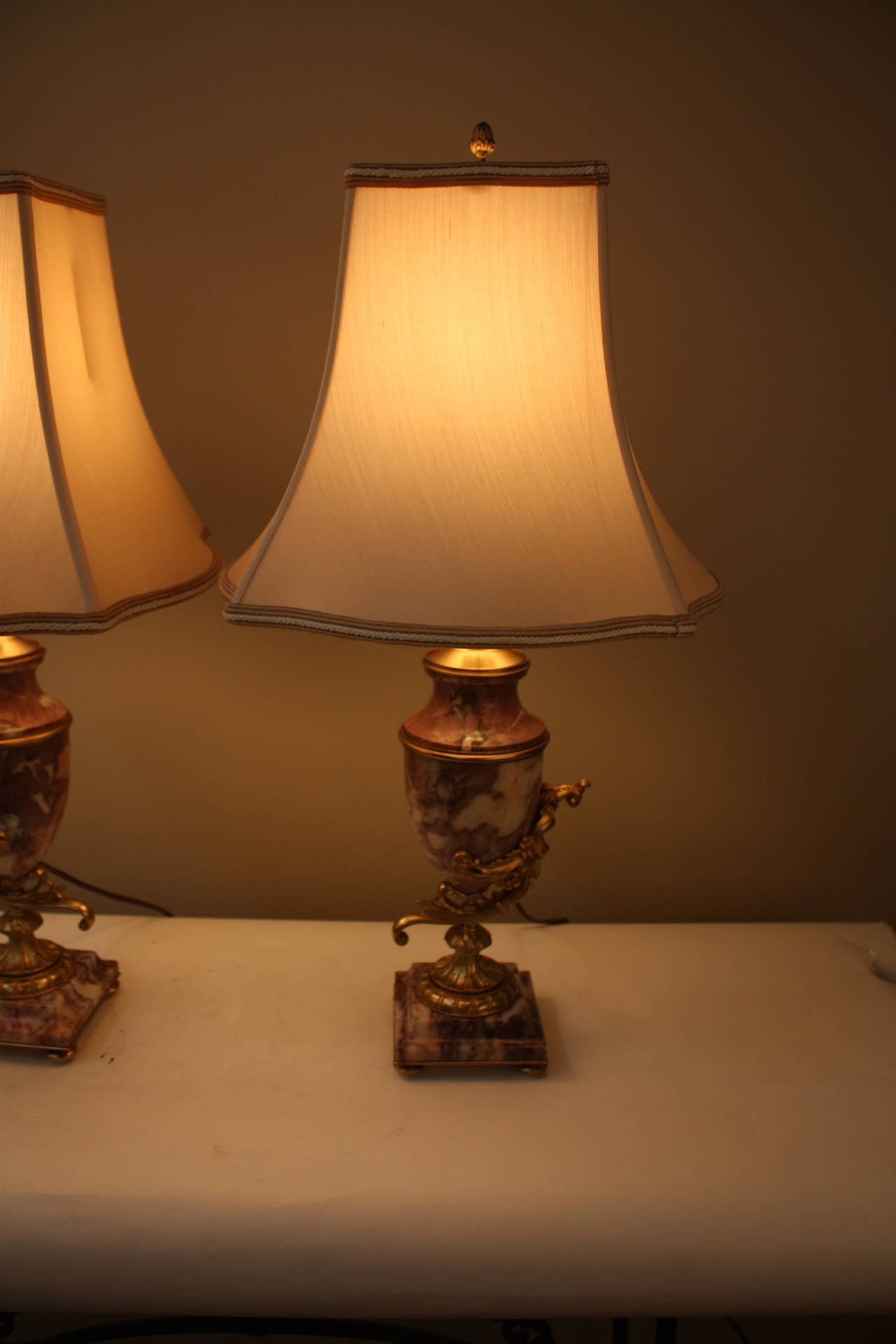 Pair of customized lamps from elegant pair of red/ pink and white marble  and bronze. This elegant lamps are fitted with handmade silk lampshades.