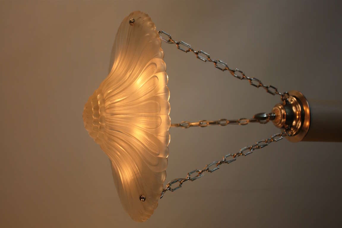 A fabulous Art Deco pendant light. This great fixture features six lights a nickel on bronze chain and canopy.