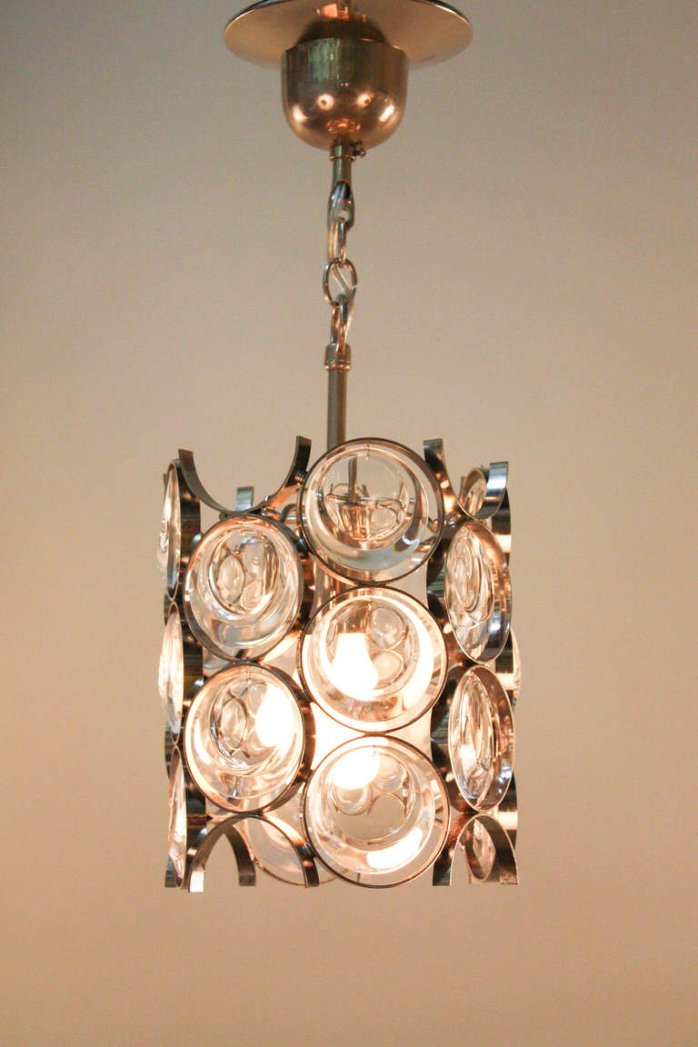 This beautiful modernist chandelier was designed and manufactured by the noted german lighting company, Palwa.  

Made of chrome on bronze, this elegant yet minimalist chandelier features a beautiful geometric design made of crystal.