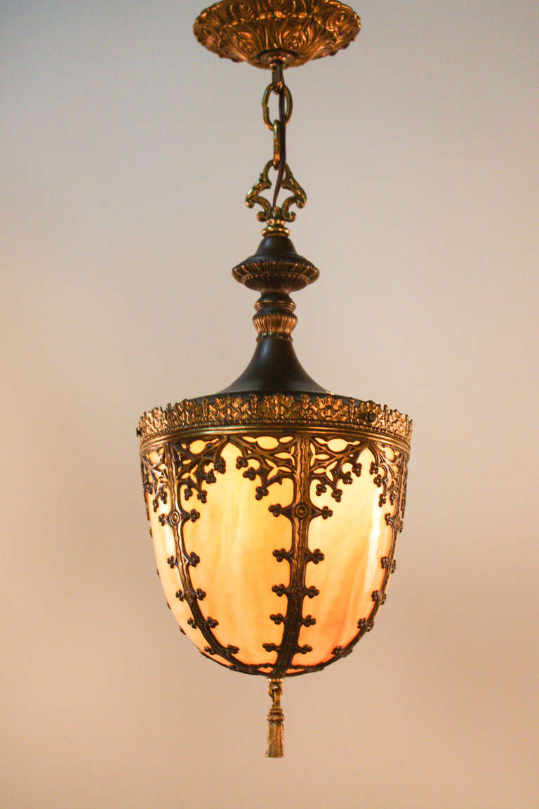 A wonderful flush mount ceiling light. Made in America during the 1930's, this  piece features six carved stained glass panels, and is accented by beautiful metal work.

This is a single light fixture compatible with lightbulbs up to 150 watts.