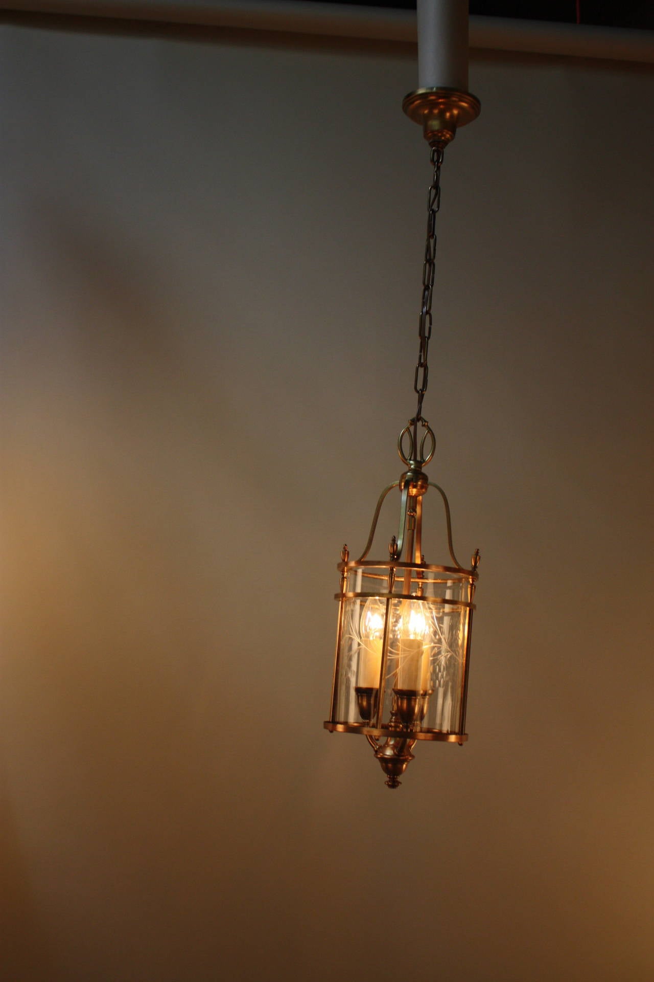 Elegantly design American three-light brass lantern with cut-glass cylinder shade.