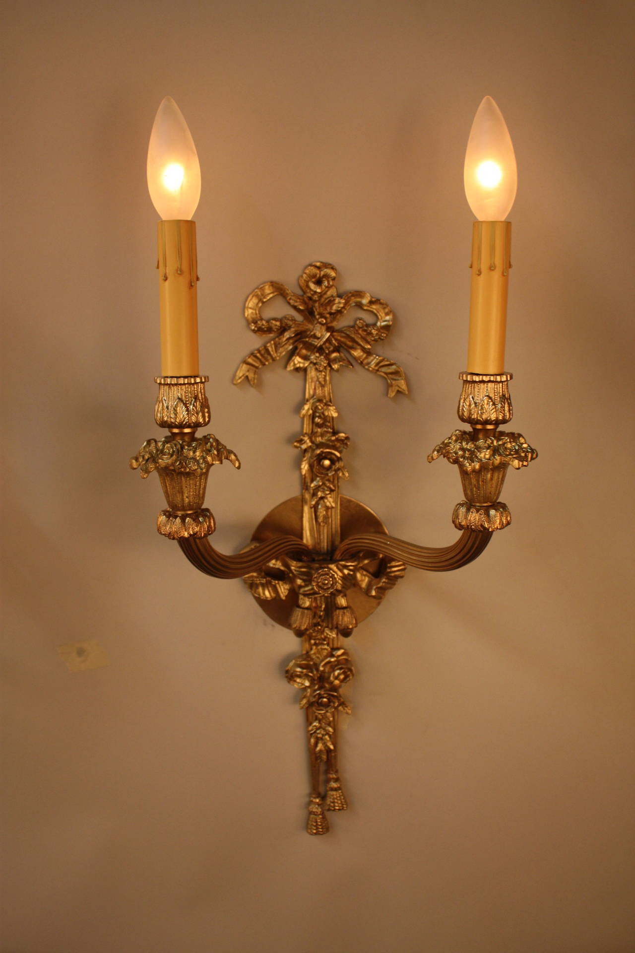 A wonderful designed pair of double arm French bronze wall sconces.