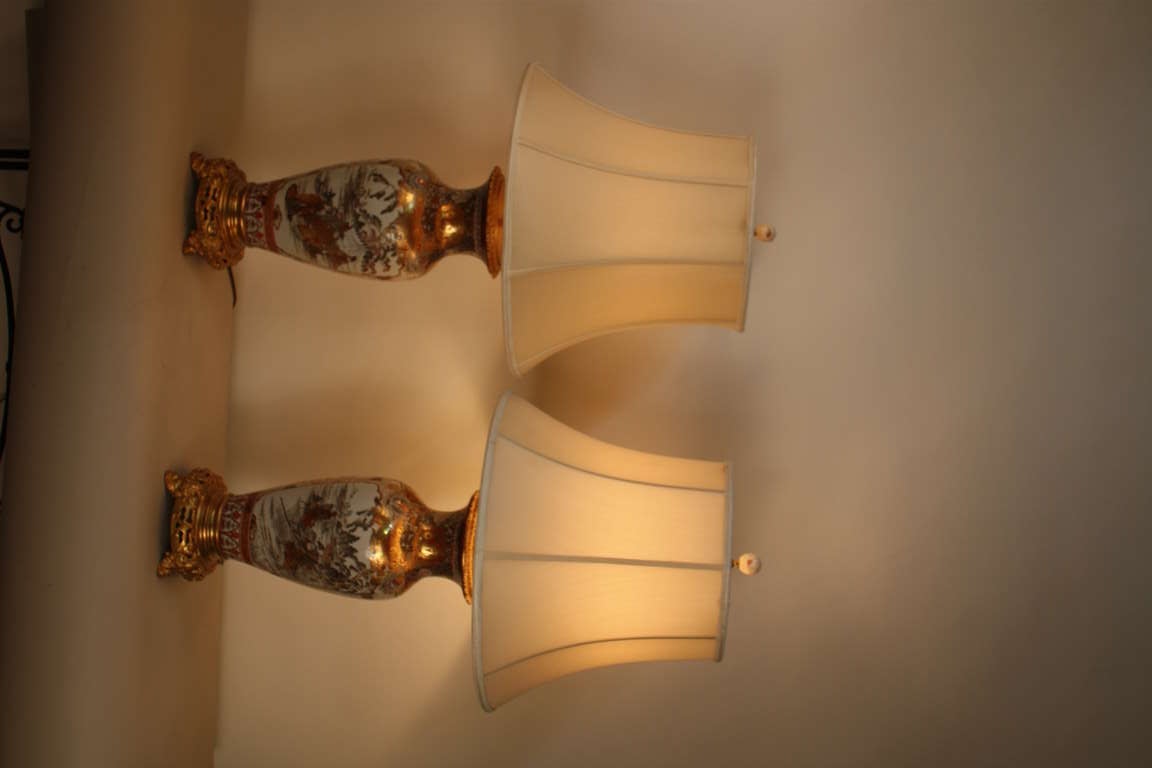This great pair of royal Satsuma vases has a fascinating history. Imported to France from Japan in the 19th century, the pair were converted from a vases into oil lamps, and beautiful bronze mounting was added to the piece. 

We have lovingly