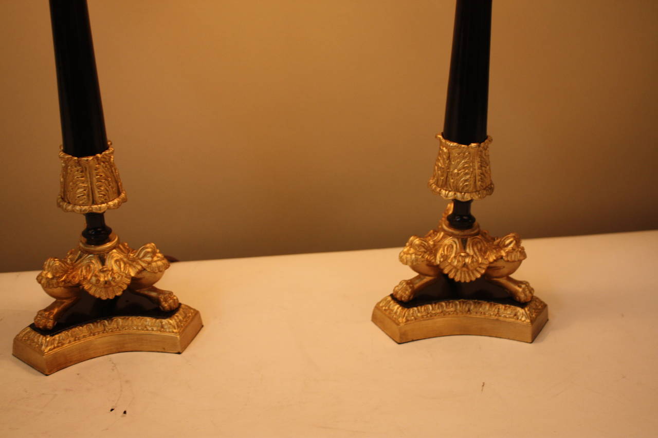 Fabulous pair of late 19th century Empire candlesticks that have been electrified and fitted with fine silk lampshades.