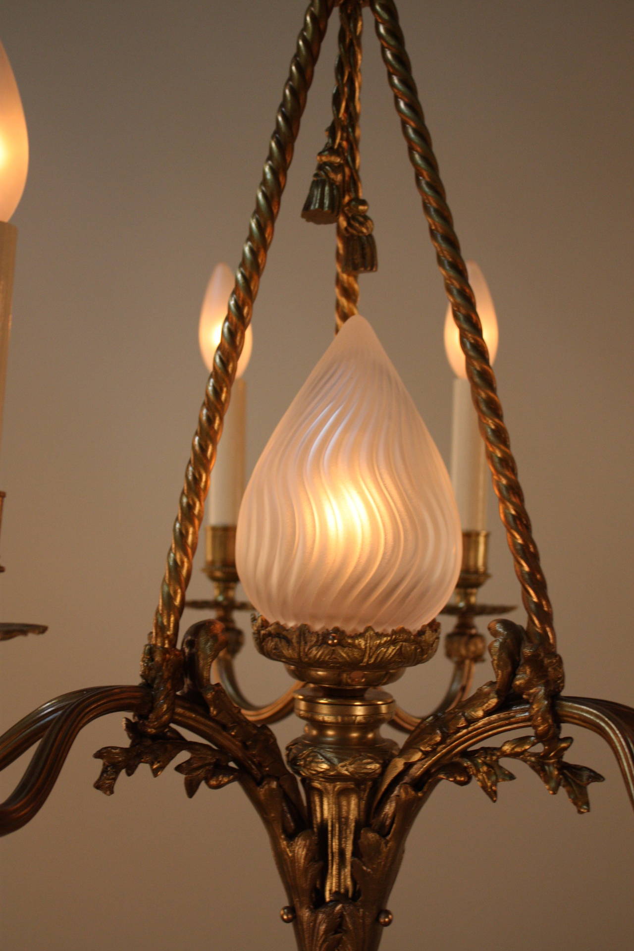 Elegant six candle light with center glass torchlight bronze chandelier.