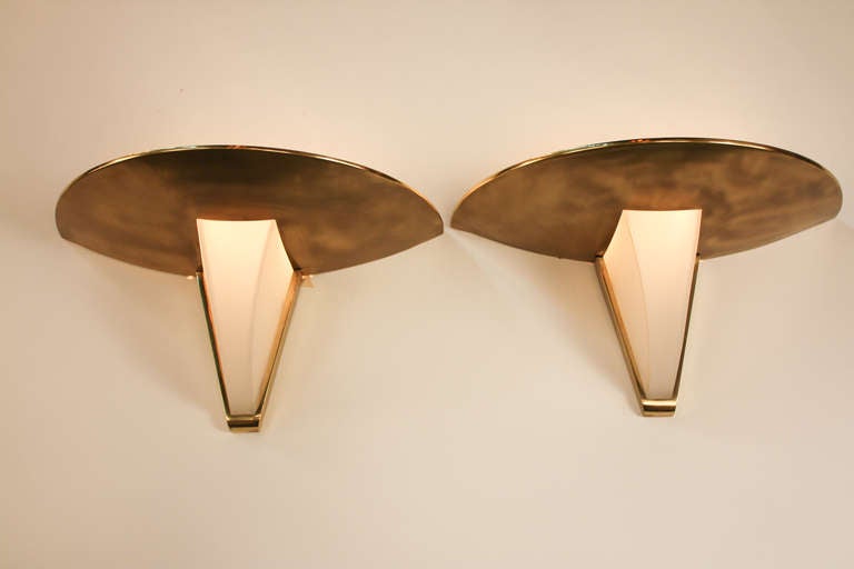 These elegant Art Deco wall sconces feature an elegant bronze and glass design. Signed by the artist, world renowned lighting designer Jean Perzel; this fixture is truly remarkable. Please note that there is a separate listing for a single wall