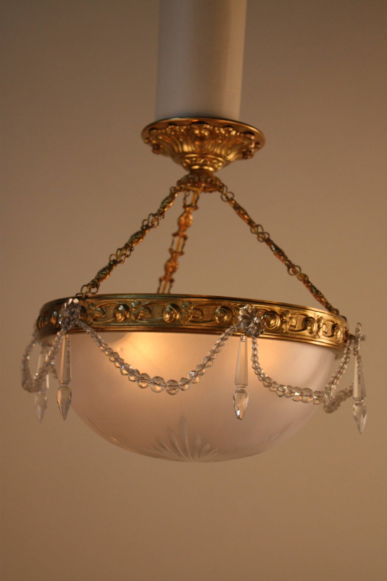 A beautiful three-light cut-glass and bronze hanging light.