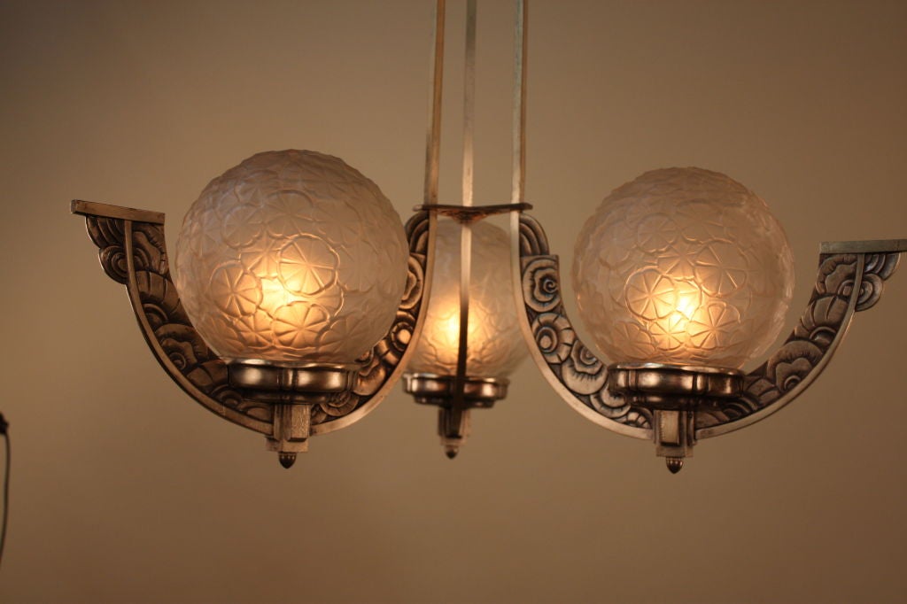 ART DECO SILVER ON BRONZE CHANDELIER WITH THREE MOLDED GLASS SHADES