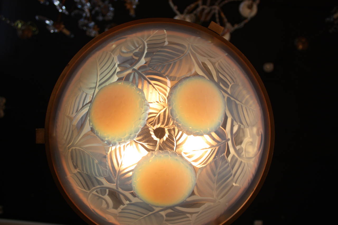 A beautiful hanging ceiling light. Crafted in France during the 1930s, this piece bears the signature of maker.