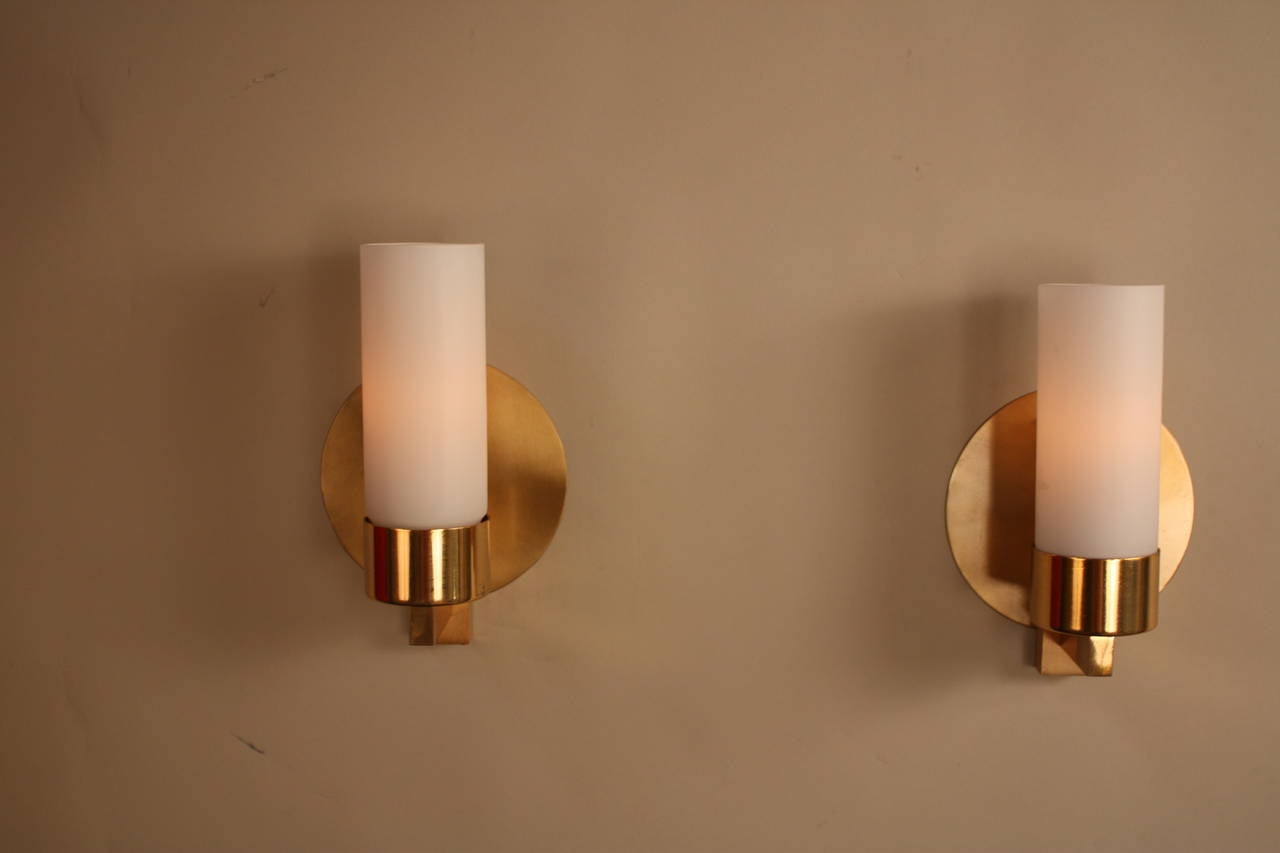 Simple but elegant pair of 1970s, Italian bronze and glass wall sconces.