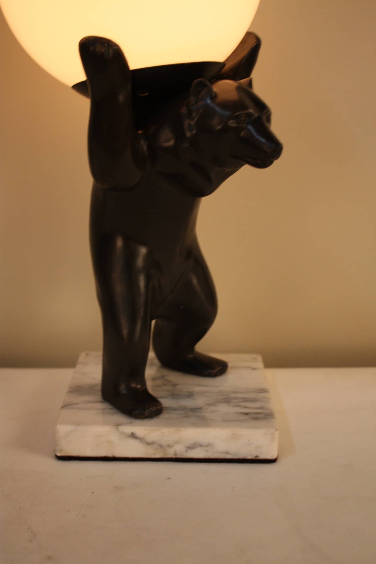 Beautiful bronze bear sculpture lamp with white opal glass shade.