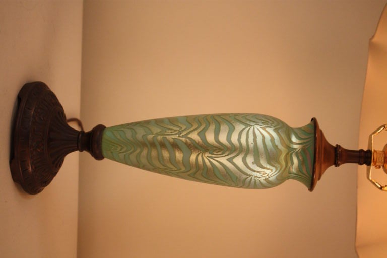 THIS ELEGANT LAMP WITH BEAUTIFUL WAVE IRIDESCENT DURAND GLASS SHOWS THE WORKMANSHIP OF EARLY 20S CENTURY