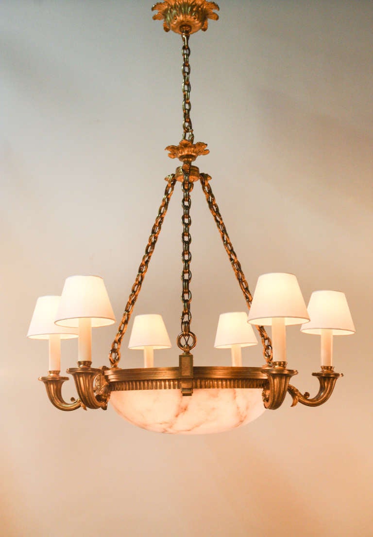 This beautiful six arm, Alabaster Chandelier features nine external candle lights, plus additional lighting that illuminates the alabaster for a total of 15 lights. 

This gorgeous piece really demonstrates the beauty of the alabaster. The 
