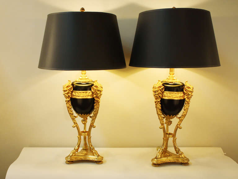 These beautiful French bronze table lamps were originally made in the 19th century as oil lamps. They have since been professionally electrified and are ready for use. 

This pair of lamps features a black lacquer over bronze design, a gorgeous