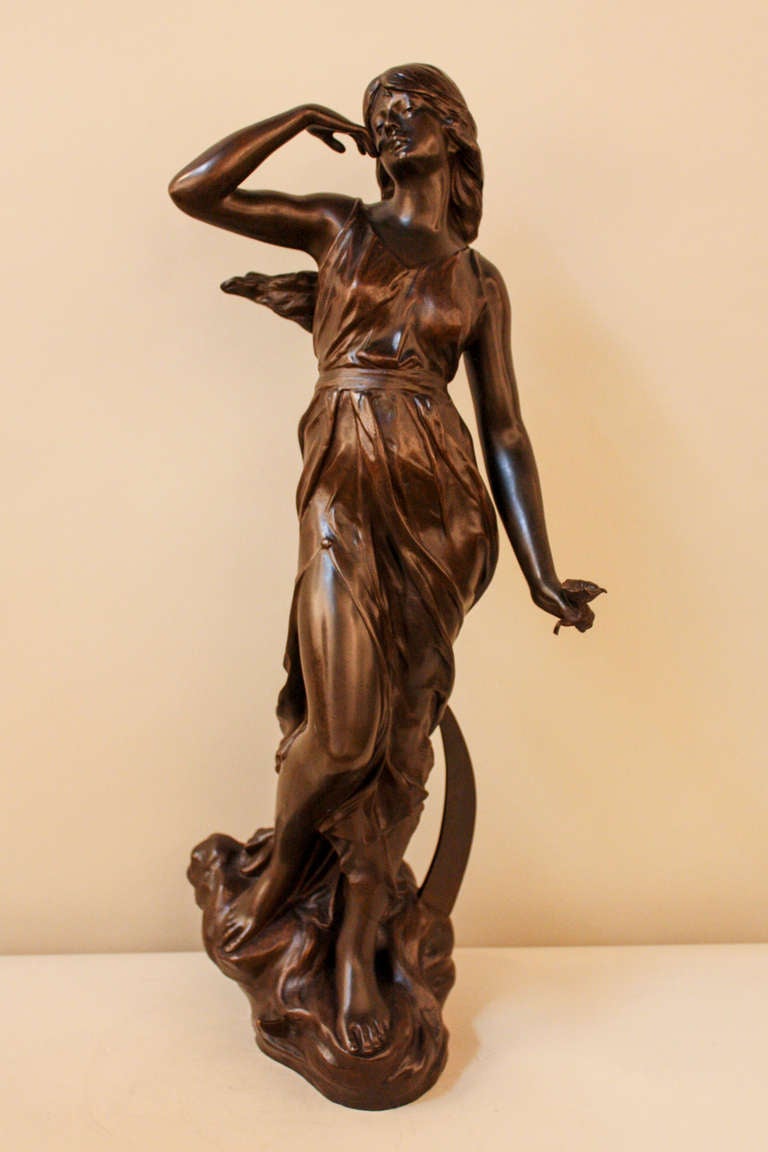 Crafted in France just after the start of the 20th century, this fabulous Art Nouveau bronze depicts a beautiful woman standing on a cloud. The crescent moon floats behind her, while she holds a flower in her outstretched hand.

Sculpted and